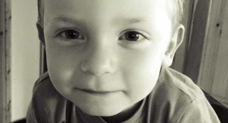 This is Aaron. His mum has chained herself to the Dept. gates in a row over his education.