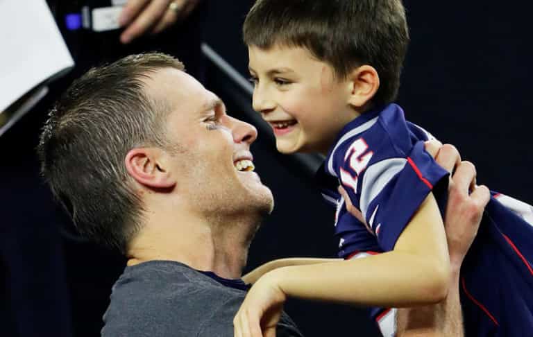 American footballer faces criticism for kissing 11-year-old son on the lips
