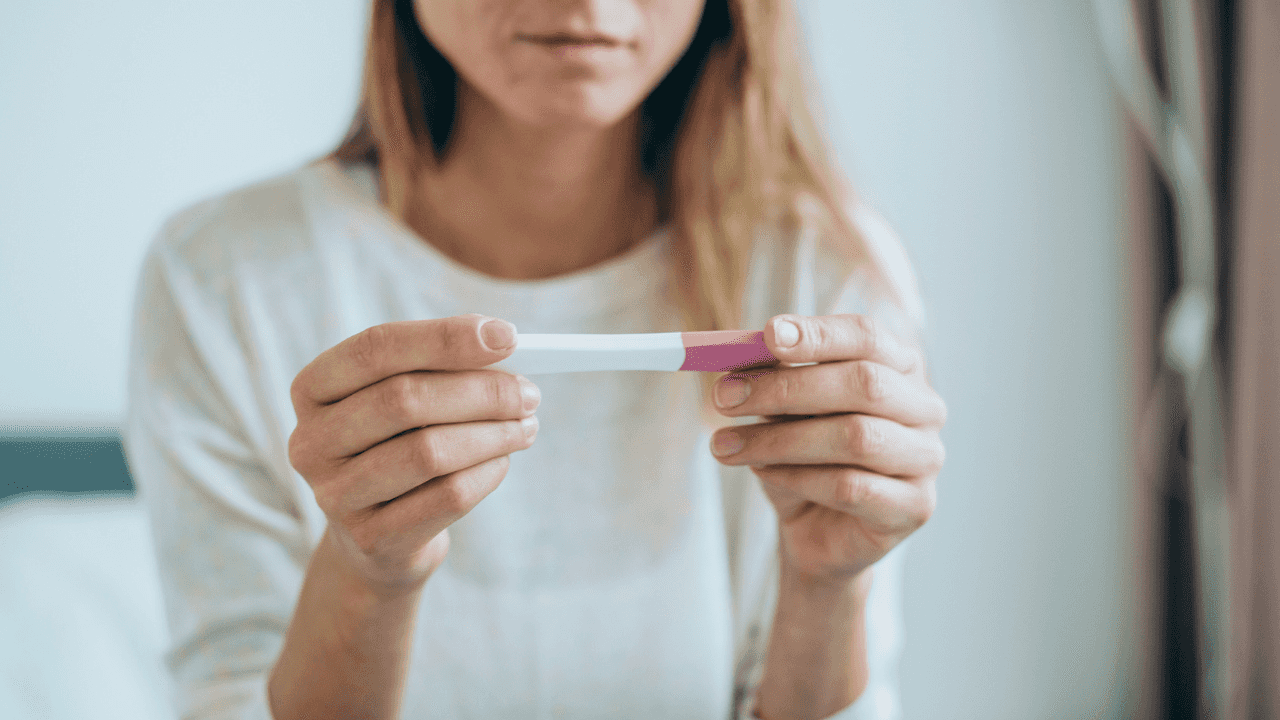 What is an ectopic pregnancy and what are the symptoms?