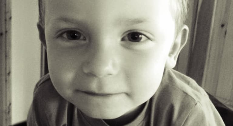 This is Aaron. His mum has chained herself to the Dept. gates in a row over his education.
