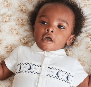 This smocked baby bodysuit from Next is giving us royal vibes This smocked baby bodysuit from Next is giving us royal vibes