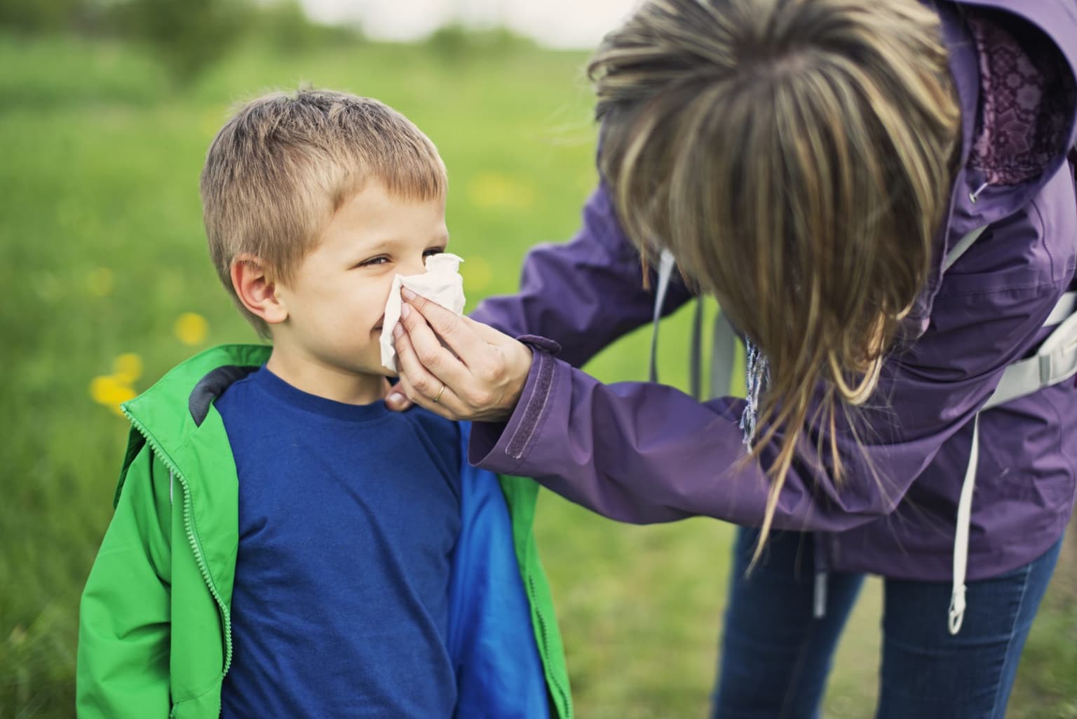 Mum wiping her child's nose