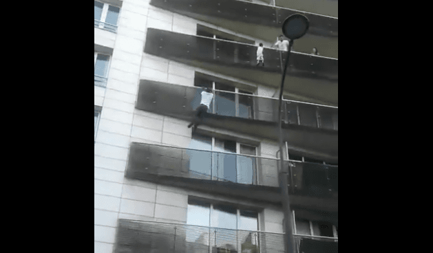 Man hailed a hero after he climbs a building to save a dangling toddler Man hailed a hero after he climbs a building to save a dangling toddler
