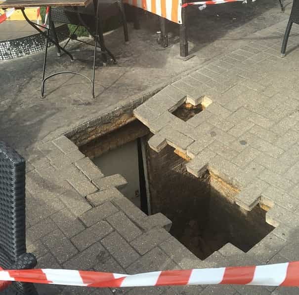 Woman swallowed by huge hole outside café Woman swallowed by huge hole outside café
