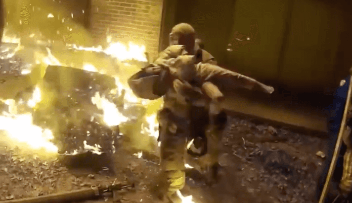 Shocking footage shows incredible rescue of child thrown from house fire Shocking footage shows incredible rescue of child thrown from house fire