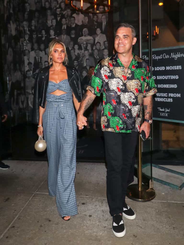 Robbie Williams embraces dad duty as he struggles with Christmas tree star Robbie Williams embraces dad duty as he struggles with Christmas tree star